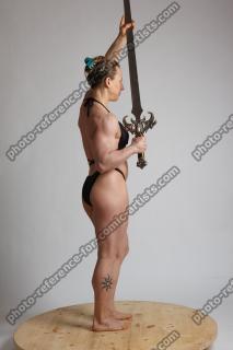 EVA STANDING HOLDING SWORD